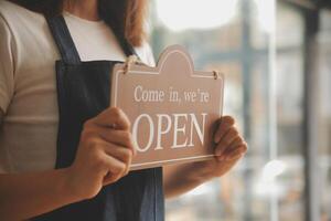 avvio di successo della piccola impresa titolare sme bellezza ragazza stand con tablet smartphone nel ristorante caffetteria. ritratto di donna asiatica abbronzata barista barista proprietario. concetto di business venditore imprenditore PMI foto