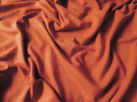 arancia tessuto sfondo, di seta pendenza lusso tessuto struttura, estate tessile bandiera Materiale tropicale onda Guarda moda astratto design manifesto modello foto