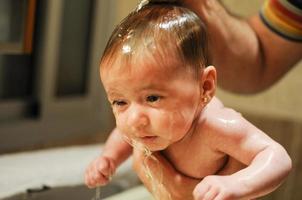bambina di due mesi che fa il bagno foto