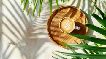 cappuccino caffè su il legna piatto e tropicale foglie, estate sfondo foto