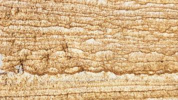 la superficie di arenaria con venature ondulate marroni. struttura dell'agata solforata. ampia immagine di sfalerite texture pietra naturale marrone. bellissimo motivo ondulato di taglio di pietra schalenblende close-up foto