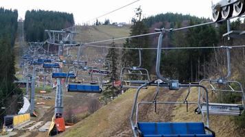 Ucraina, Bukovel - 20 novembre 2019. Vista autunnale della stazione sciistica con una seggiovia sullo sfondo dei pendii montani autunnali e l'infrastruttura in costruzione di una stazione sciistica invernale. foto