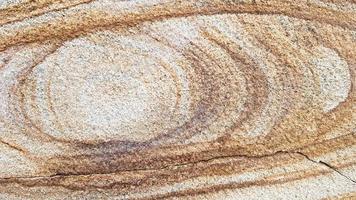 la superficie di arenaria con venature ondulate marroni. struttura dell'agata solforata. ampia immagine di sfalerite texture pietra naturale marrone. bellissimo motivo ondulato di taglio di pietra schalenblende close-up foto