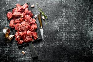 tagliare crudo Manzo con timo, aglio e olio nel un' bottiglia. foto