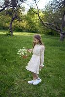 un' ritratto di un' ragazza nel un' pastello vestito con un' cestino di fiori nel il giardino foto