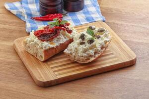 bruschetta con capperi al formaggio molle e pomodoro foto