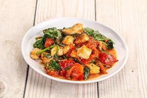 pollo con pomodoro e spinaci foto