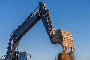 vicino su dettagli di industriale scavatrice Lavorando su costruzione luogo 3 foto