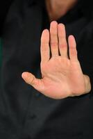 maschio mani disteso nel saluto isolato su nero sfondo. foto