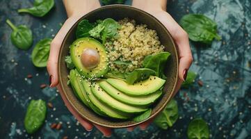 donna Tenere ciotola di quinoa, avocado, e spinaci insalata foto