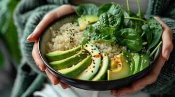 donna Tenere ciotola di quinoa, avocado, e spinaci insalata foto