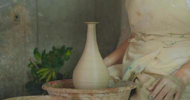 primo piano del lavoro manuale della donna con l'argilla in studio di ceramica foto