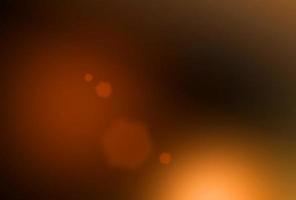 astratto bagliore di sole motivo di sovrapposizione arancione chiaro con raggi astratti trama incandescente su nero scuro. foto