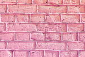 muro di pietra perfettamente organizzato, trama rosa dalla trama di sfondo del muro di roccia foto