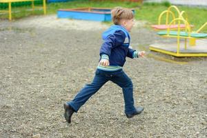 fantastico ragazzo ucraino che corre per il parco giochi foto