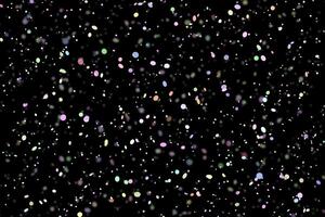 scintilla colorata astratta elegante effetto di luce su uno sfondo nero e scintilla particelle di polvere magiche scintillanti su nero foto