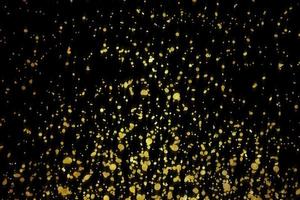 luce gialla scintilla astratta elegante effetto di luce su uno sfondo nero e scintilla particelle di polvere magiche scintillanti su nero foto