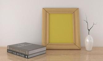 Rendering 3D di un mockup di cornice vuota gialla accanto a libri e un vaso su una superficie di legno foto