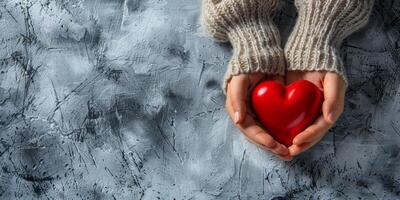 un' commovente Immagine di amore Spettacoli mani cullare un' vivace rosso cuore contro un' strutturato, bellissimo sfondo foto