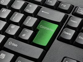 una tastiera nera con tasto verde coronavirus foto