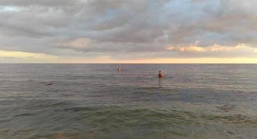 giovane che fa il bagno sulla spiaggia nel pomeriggio foto