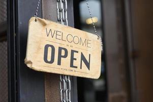 aprire il cartello nella porta della caffetteria, l'attività riapre dopo il concetto di focolaio di covid-19. foto