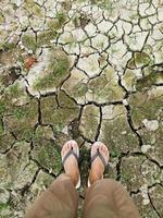 selfie di piedi su terreno screpolato. tessitura del terreno screpolata foto