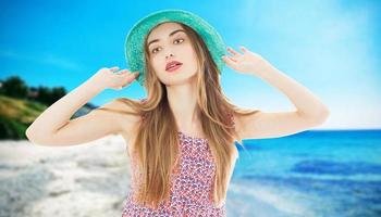 donna sorridente in vacanza con cappello da sole in mare o oceano. foto