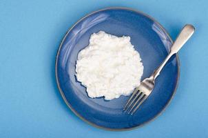 latticini. ricotta fatta in casa bianca fresca sul piatto blu. foto in studio