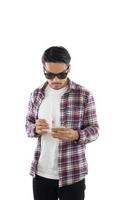 giovane uomo hipster guardando il suo smartphone mentre messaggi di testo isolati su sfondo bianco. foto