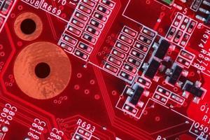 circuito stampato elettronico in rosso con componenti elettronici foto