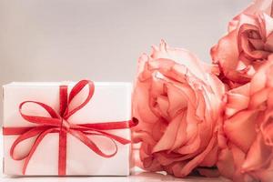 rosa rosa e confezione regalo su sfondo verde brillante. foto
