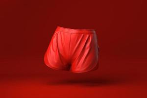 pantaloncini rossi su sfondo rosso. idea di concetto minimale creativa. monocromo. rendering 3d. foto
