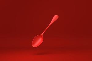cucchiaio rosso galleggiante su sfondo rosso. idea di concetto minimale creativa. monocromo. rendering 3d. foto