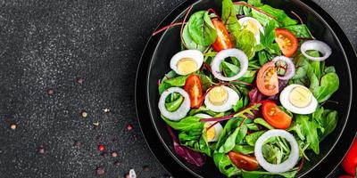 insalata uovo di quaglia mix di pomodoro foglie vegetali pasto sano cibo vegano o vegetariano foto