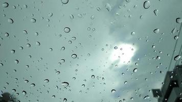 gocce di pioggia sullo sfondo della finestra di vetro foto