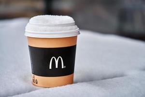 obninsk, russia - gennaio 4,2019. tazza di caffè di carta di mcdonald in piedi sul tavolo coperto di neve foto