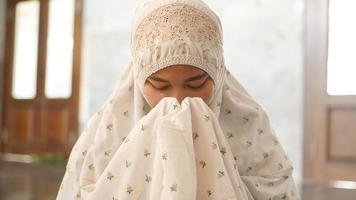 donna musulmana asiatica che prega si spera nella moschea foto