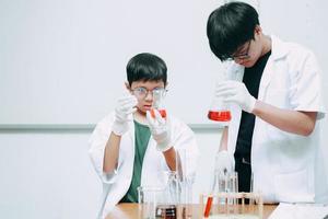 insegnante di scienze e studente che fanno esperimenti in laboratorio foto