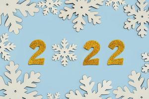 felice anno nuovo 2022. numeri d'oro 2022 con fiocchi di neve. sfondo del concetto di celebrazione della vigilia di capodanno foto