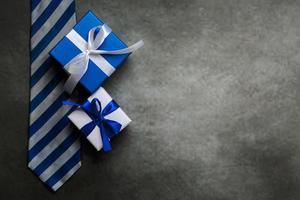 buona festa del papà. vista dall'alto di scatole regalo, cravatta e spazio per la copia. concetto di celebrazione della festa del papà foto