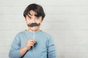 buona festa del papà, ragazzo con finti baffi sul bastone foto