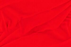 sfondo di struttura del tessuto rosso. sfondo di stoffa astratta con onde morbide. foto