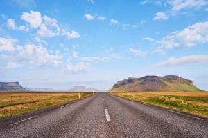 strada asfaltata verso le montagne islandesi. mondo della bellezza foto