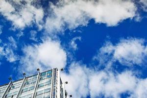 edificio moderno contro il cielo nuvoloso blu foto
