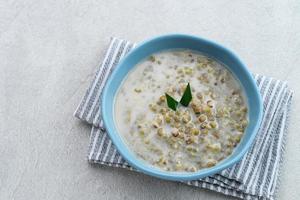 porridge di fagioli mung o bubur kacang hijau, porridge indonesiano di fagioli mung con latte di cocco, foglia di pandan e zenzero. servito in ciotola. foto