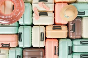 modello di molte valigie impilate con accessori da viaggio estivi foto