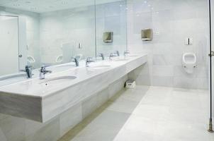 bagno pubblico vuoto per uomini con specchio per lavabo foto