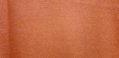 trama in tessuto morbido arancione. sfondo di cotone arancione. copia spazio per immagine o testo foto