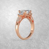 Anello di fidanzamento con 3 pietre in posizione eretta in oro rosa 3d rendering foto